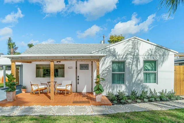 a view of a house with backyard porch and sitting area