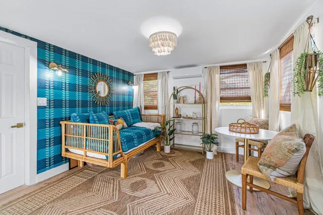 a living room with furniture a rug and a window