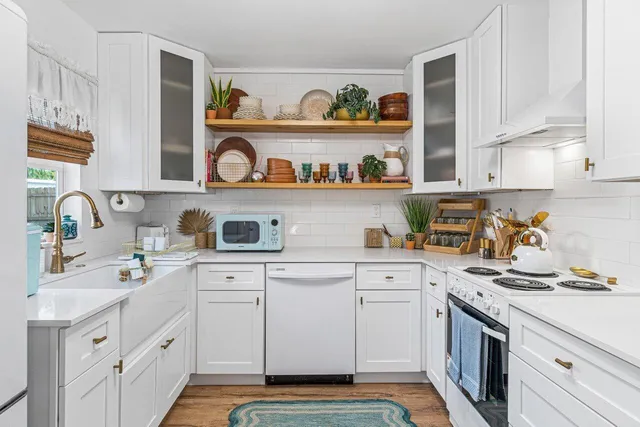 a kitchen with stainless steel appliances granite countertop a sink and wooden cabinets