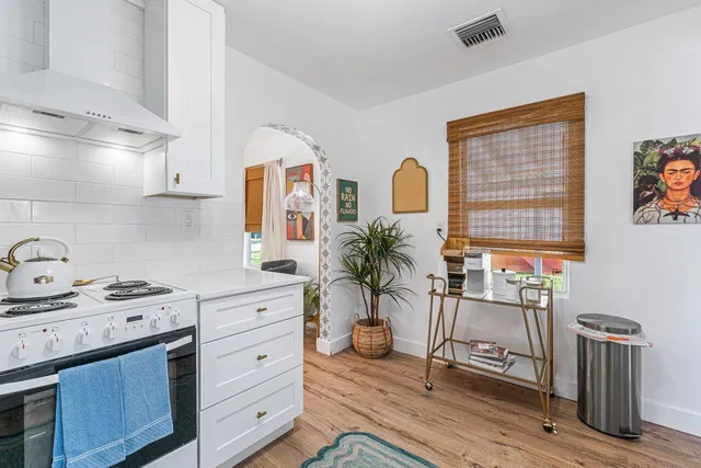 a kitchen with stainless steel appliances a stove a sink and a refrigerator