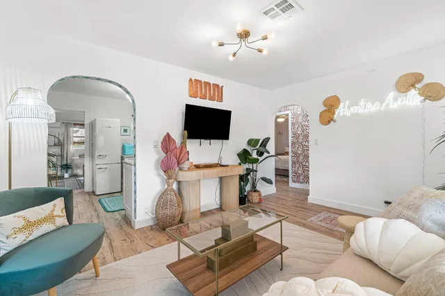a living room with furniture and a flat screen tv