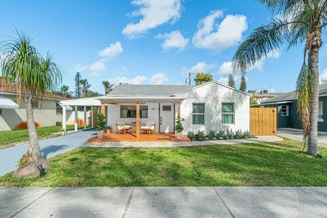 a front view of house with yard and outdoor seating