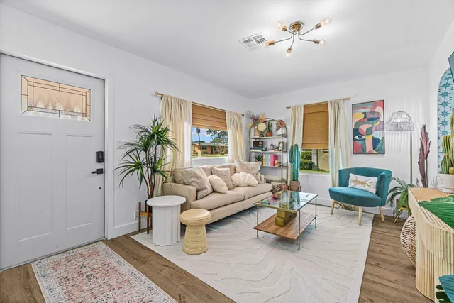 a living room with furniture and wooden floor