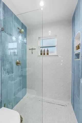 a bathroom with a shower and toilet