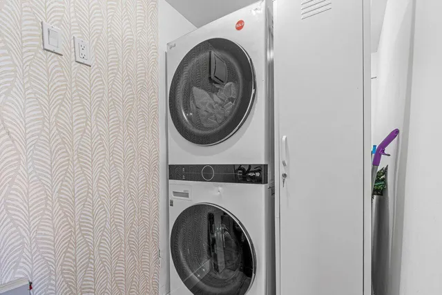 a view of a hallway with washer and dryer