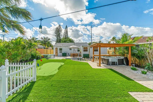 a view of a house with backyard sitting area and garden