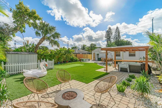 a view of a chairs and table in backyard of the house