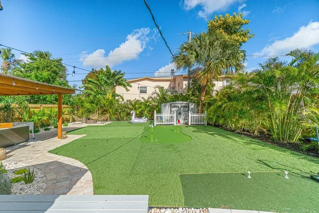a view of a backyard with sitting area