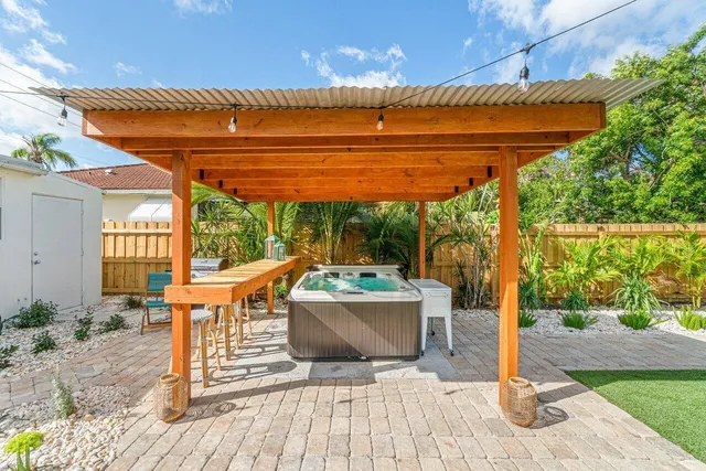 a patio with glass top table and chairs