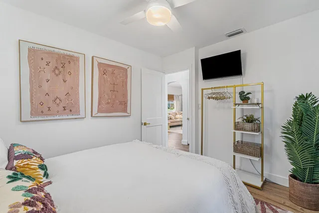 a bedroom with a bed and a television