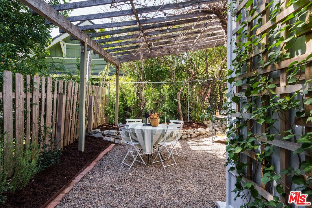 6036 Eucalyptus Lane Los Angeles, CA 90042 - Photo 29 of 34 a view of a patio with a table and chairs and potted plants