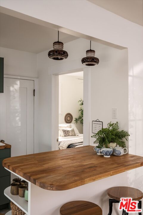 6036 Eucalyptus Lane Los Angeles, CA 90042 - Photo 7 of 34 a bedroom with a bed and a potted plant