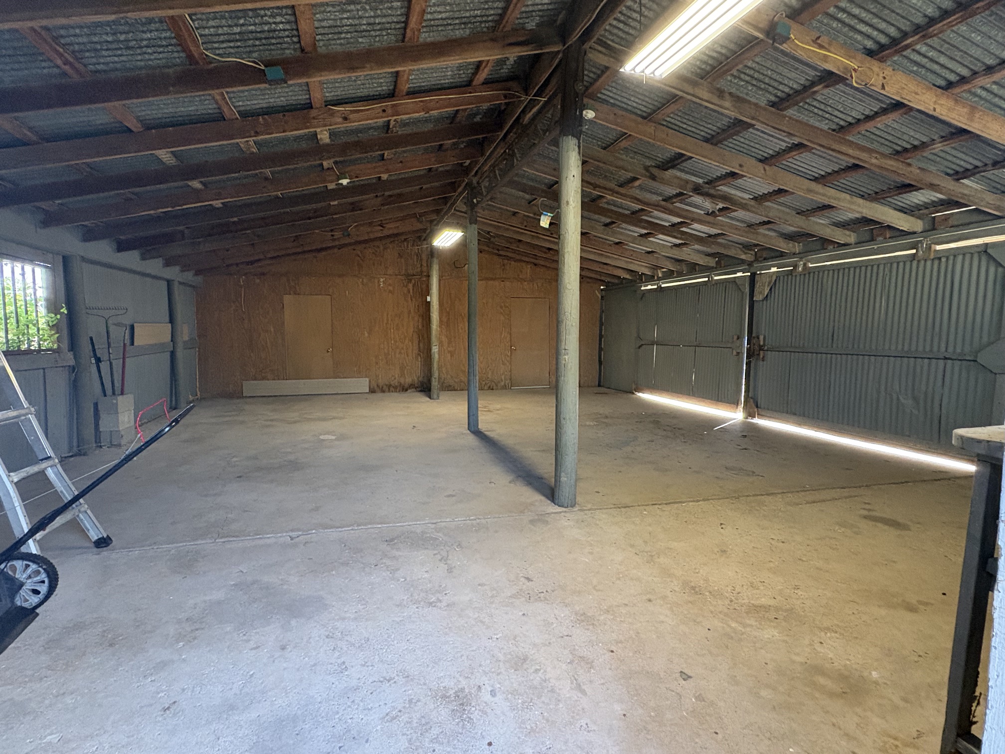 9032 Nuckols Crossing Road Austin, TX 78744 - Photo 13 of 14 A spacious, open-air garage or workshop with abundant natural light.