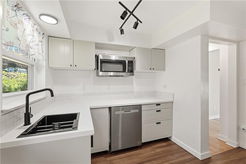 4940 3rd Street Verona, PA 15147 - Photo 12 of 27 a kitchen with a sink cabinets and wooden floor