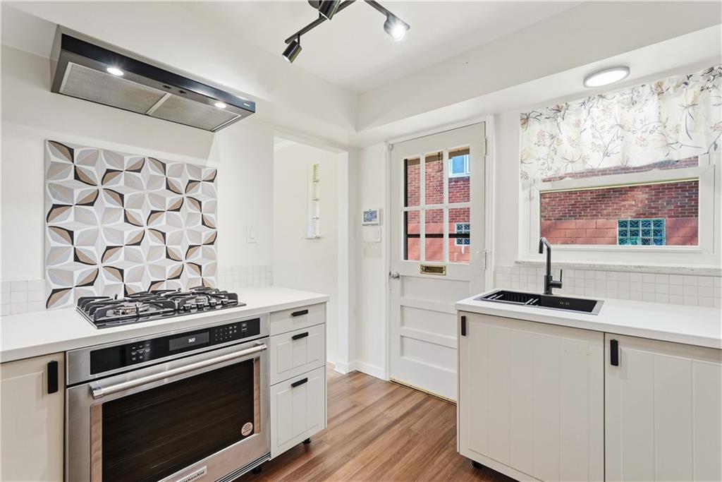 4940 3rd Street Verona, PA 15147 - Photo 14 of 27 a kitchen with stainless steel appliances a stove and a refrigerator