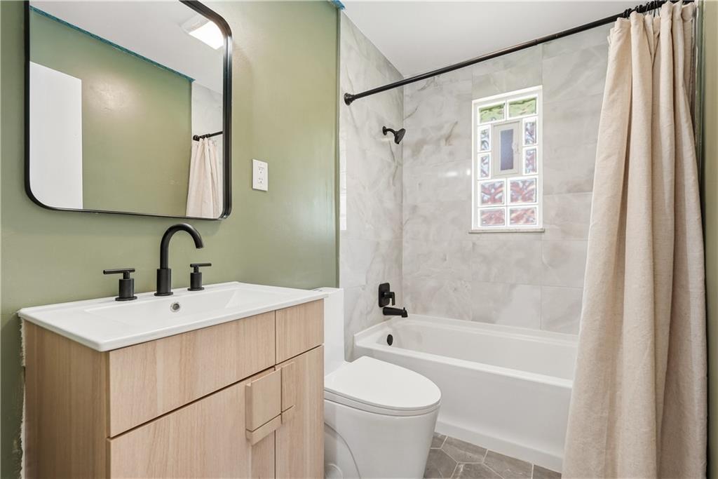 4940 3rd Street Verona, PA 15147 - Photo 16 of 27 a bathroom with a sink mirror toilet and bathtub