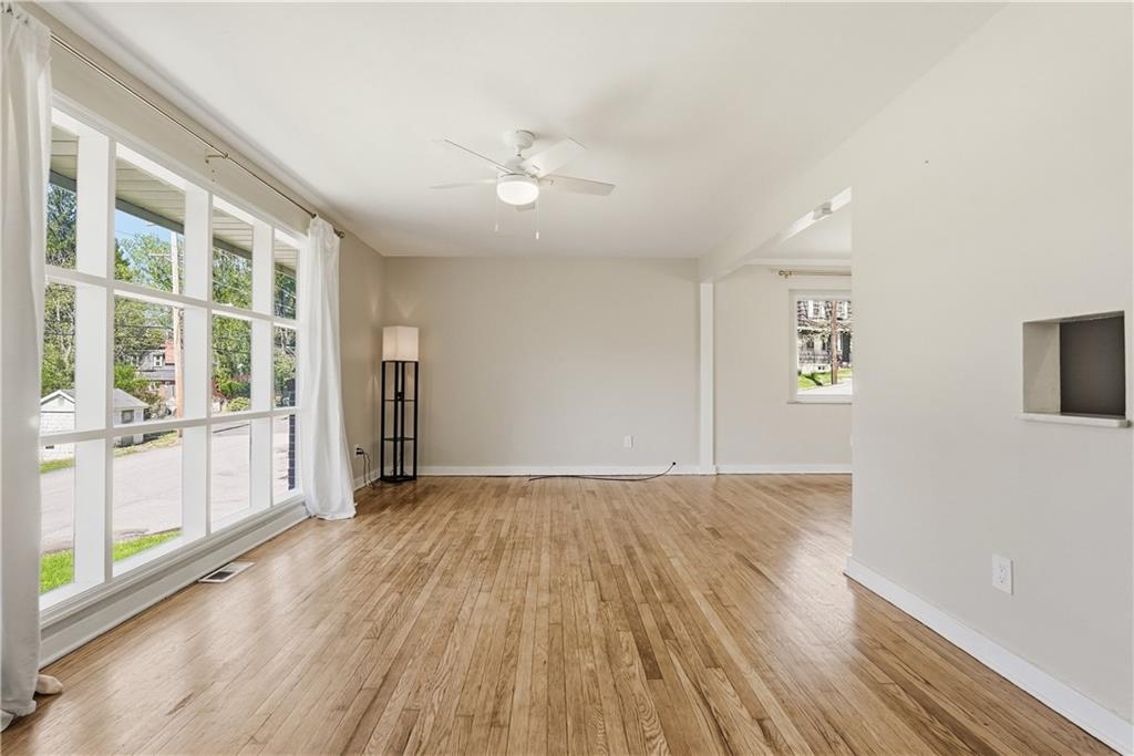 4940 3rd Street Verona, PA 15147 - Photo 6 of 27 an empty room with wooden floor and windows