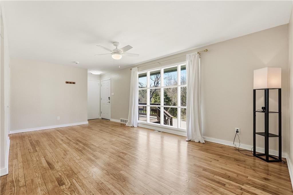 4940 3rd Street Verona, PA 15147 - Photo 7 of 27 a view of an empty room with wooden floor and a window