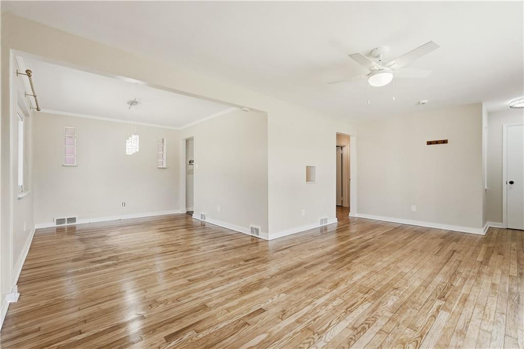 4940 3rd Street Verona, PA 15147 - Photo 8 of 27 a view of an empty room with wooden floor and a ceiling fan