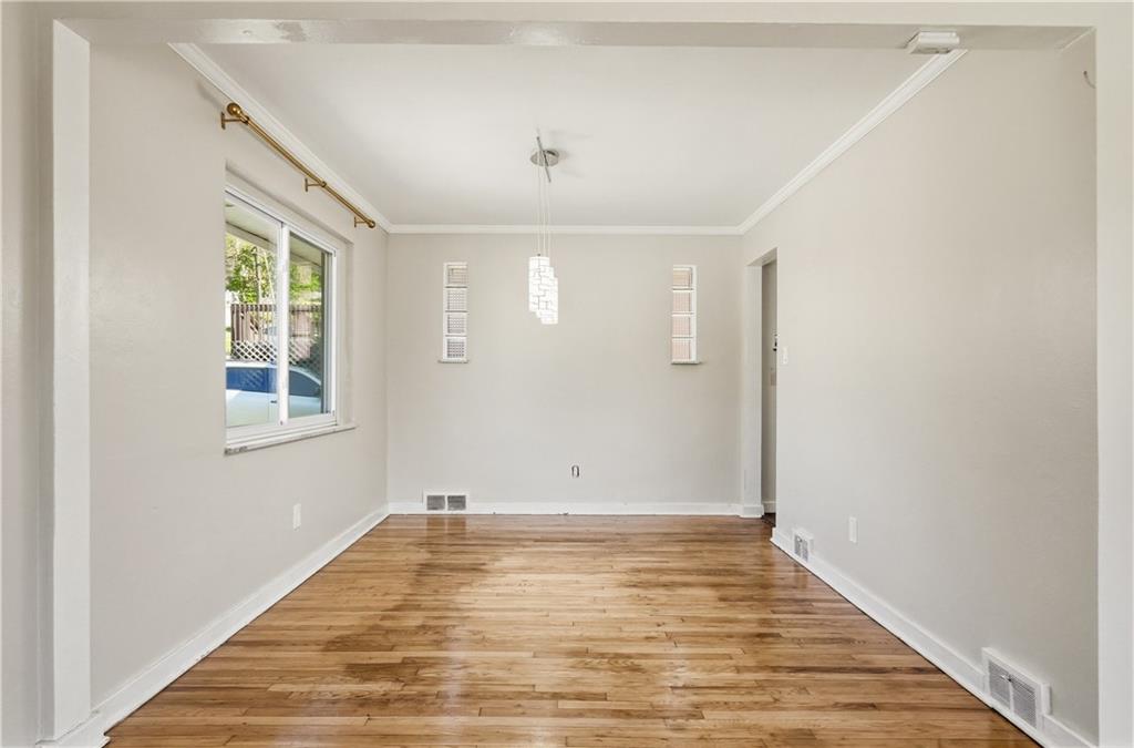 4940 3rd Street Verona, PA 15147 - Photo 9 of 27 a view of an empty room with wooden floor and a window