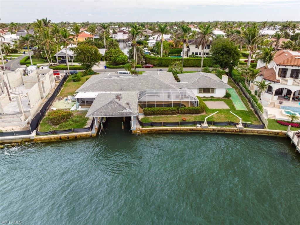 1900 Kingfish Road Naples, FL 34102 - Photo 5 of 11 swimming pool view with a garden