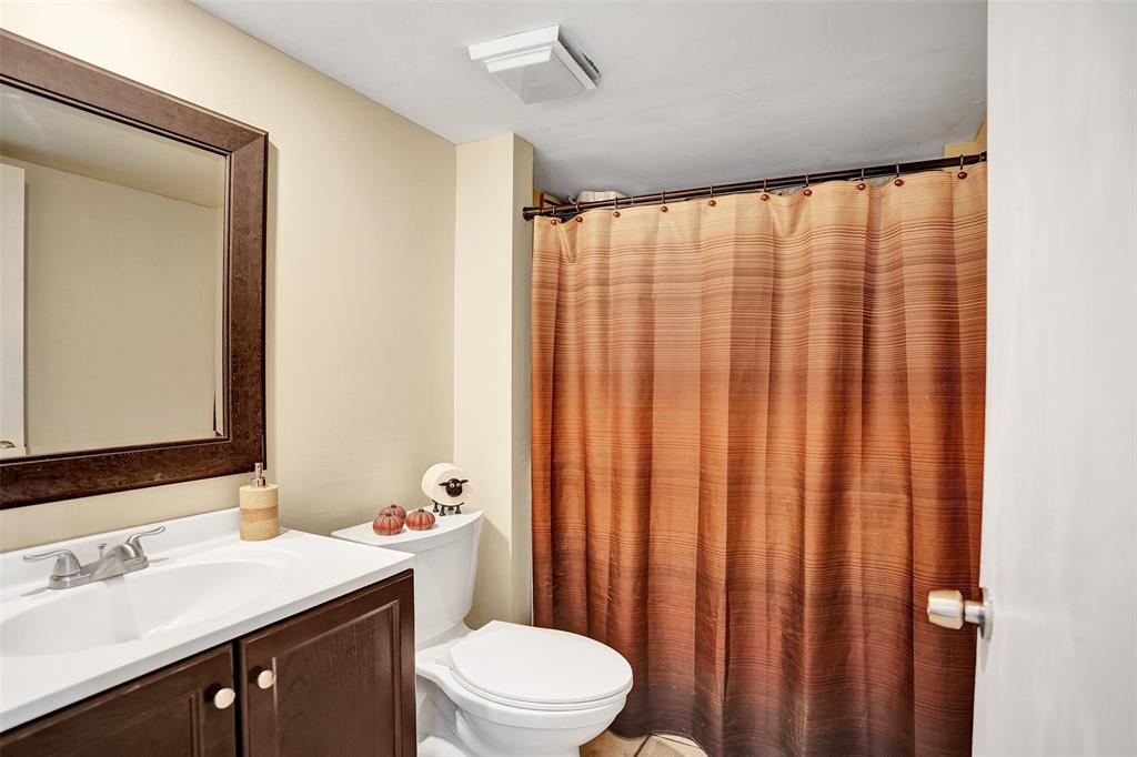1525 Augusta Circle, Unit 109 Delray Beach, FL 33445 - Photo 11 of 23 a bathroom with a sink a toilet and shower