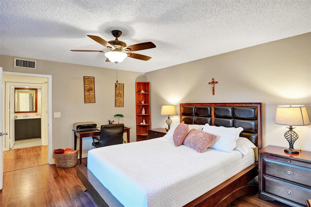 1525 Augusta Circle, Unit 109 Delray Beach, FL 33445 - Photo 13 of 23 a bed room with bed and a tv