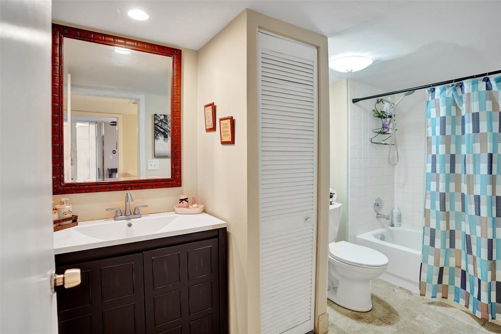 1525 Augusta Circle, Unit 109 Delray Beach, FL 33445 - Photo 18 of 23 a bathroom with a sink a toilet and shower