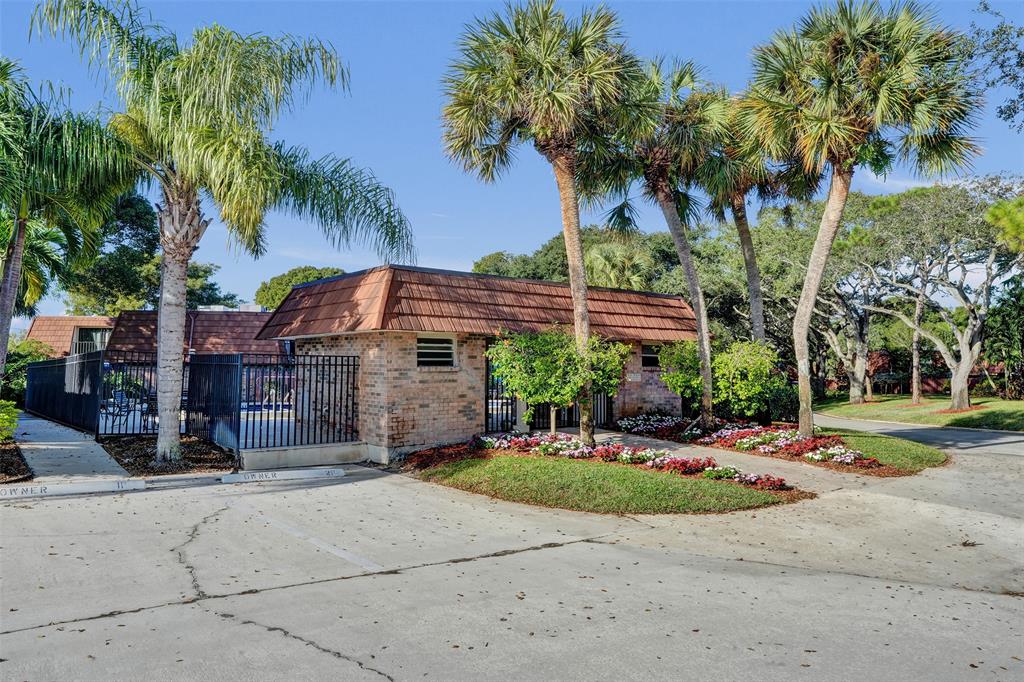 1525 Augusta Circle, Unit 109 Delray Beach, FL 33445 - Photo 22 of 23 a front view of a house with a garden