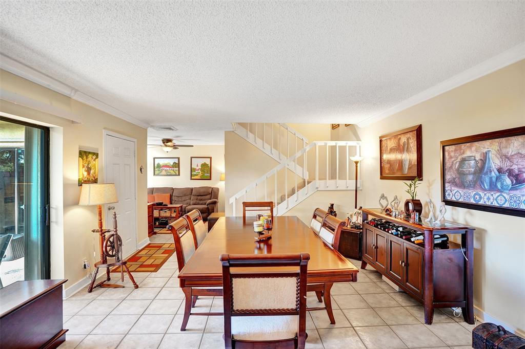1525 Augusta Circle, Unit 109 Delray Beach, FL 33445 - Photo 6 of 23 a outdoor living room with furniture and wooden floor