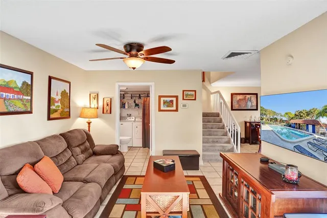 a living room with furniture and wooden floor