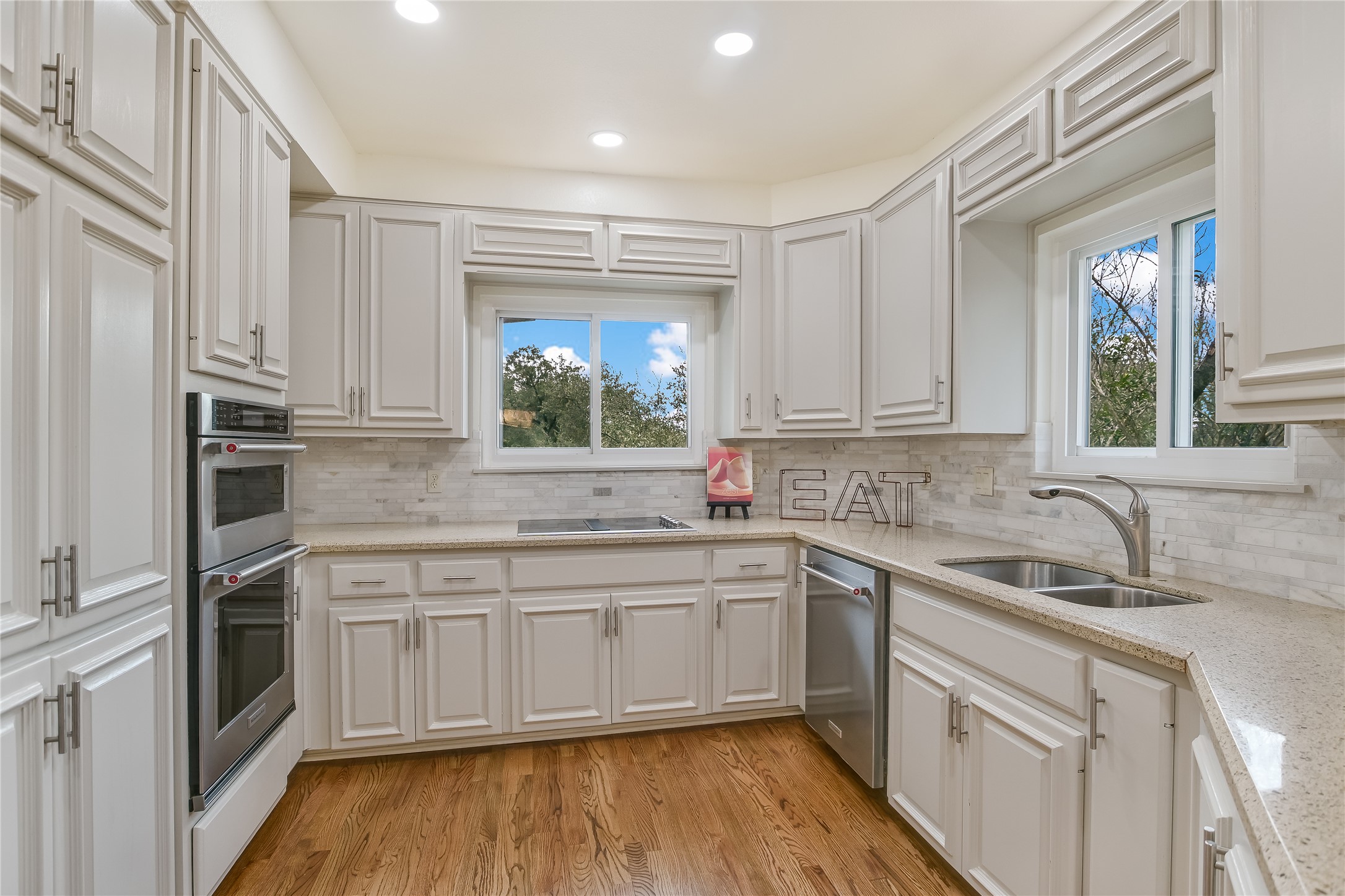 4906 Bob Cat Run Austin, TX 78731 - Photo 11 of 40 a kitchen with white cabinets appliances and sink