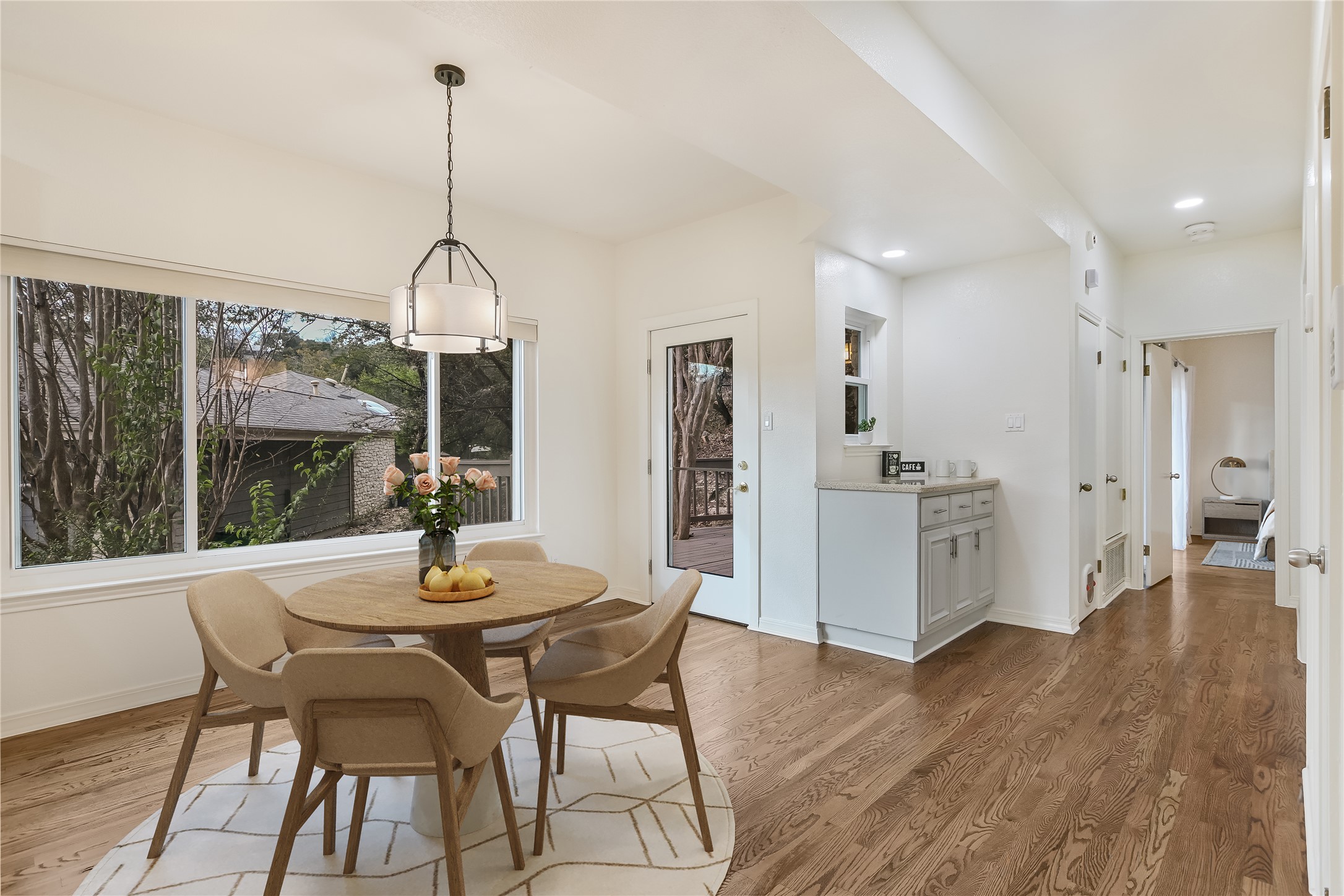 4906 Bob Cat Run Austin, TX 78731 - Photo 12 of 40 a view of a dining room and livingroom with furniture wooden floor a chandelier