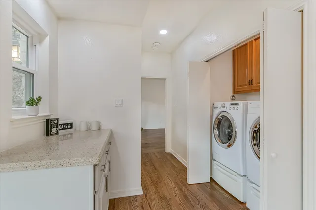 a view of a kitchen with a sink washer and dryer