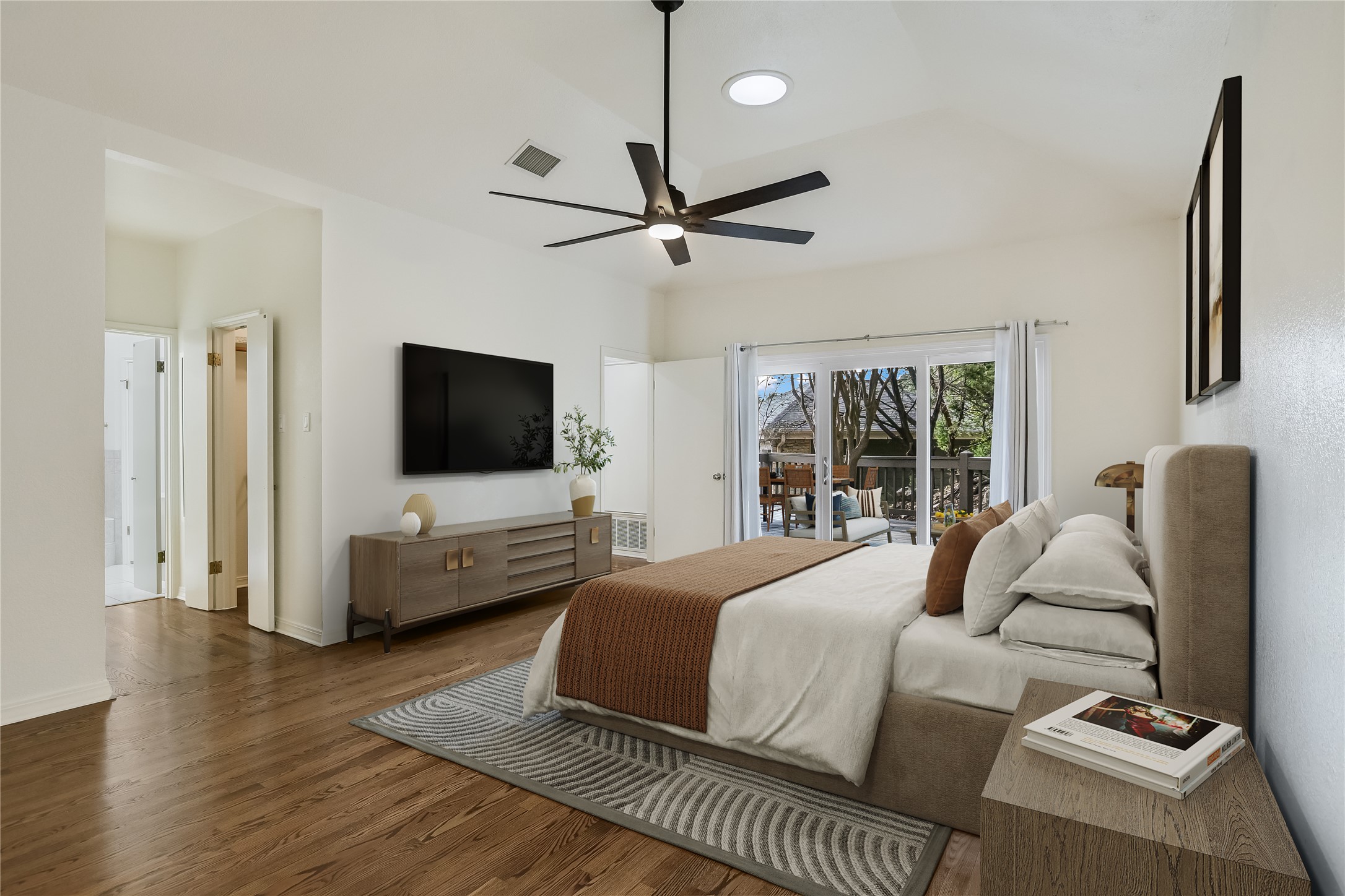 4906 Bob Cat Run Austin, TX 78731 - Photo 16 of 40 a bedroom with a bed flat screen tv and a couch