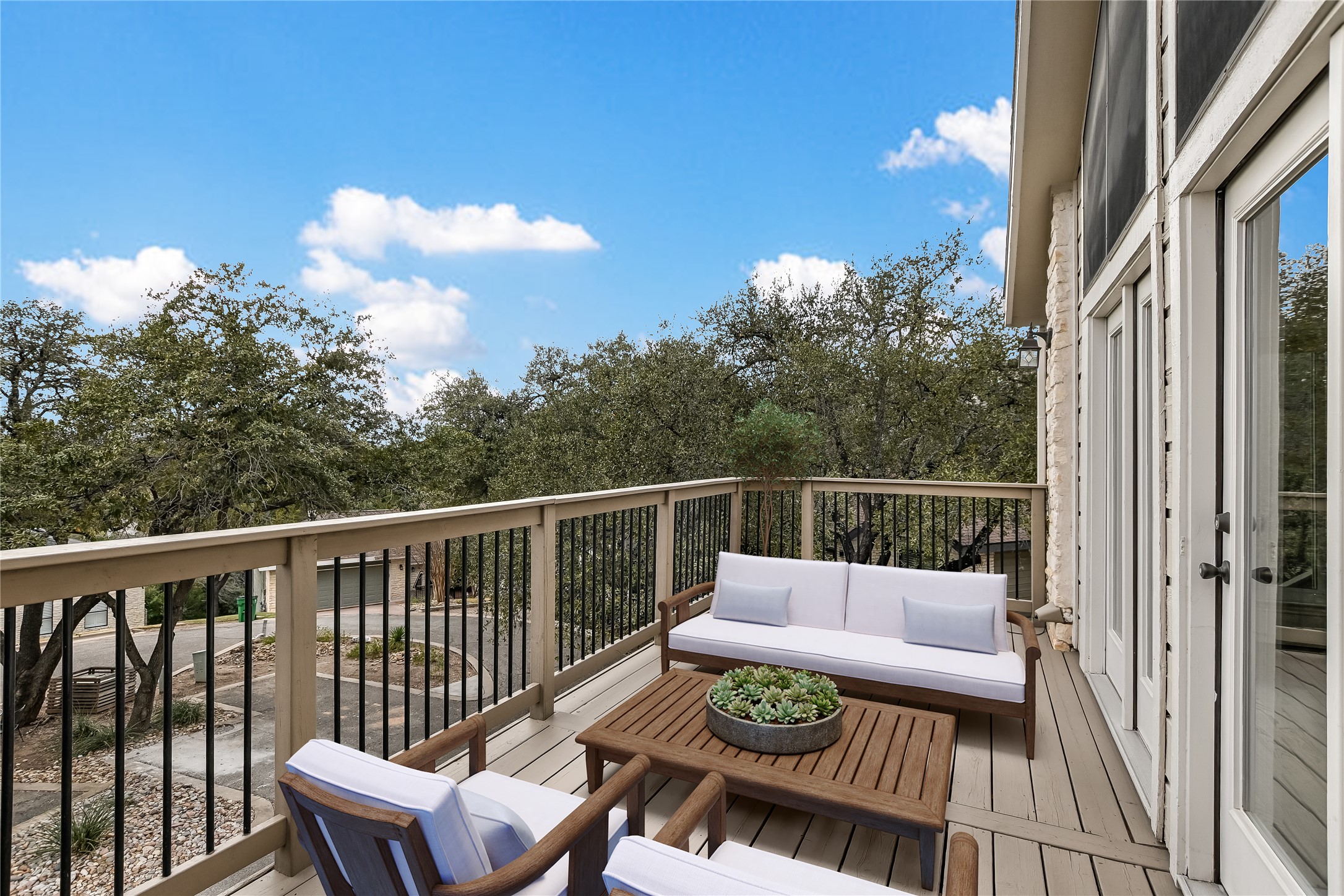 4906 Bob Cat Run Austin, TX 78731 - Photo 23 of 40 a balcony with wooden floor table and chairs