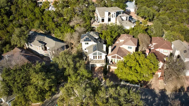 an aerial view of a house with a yard
