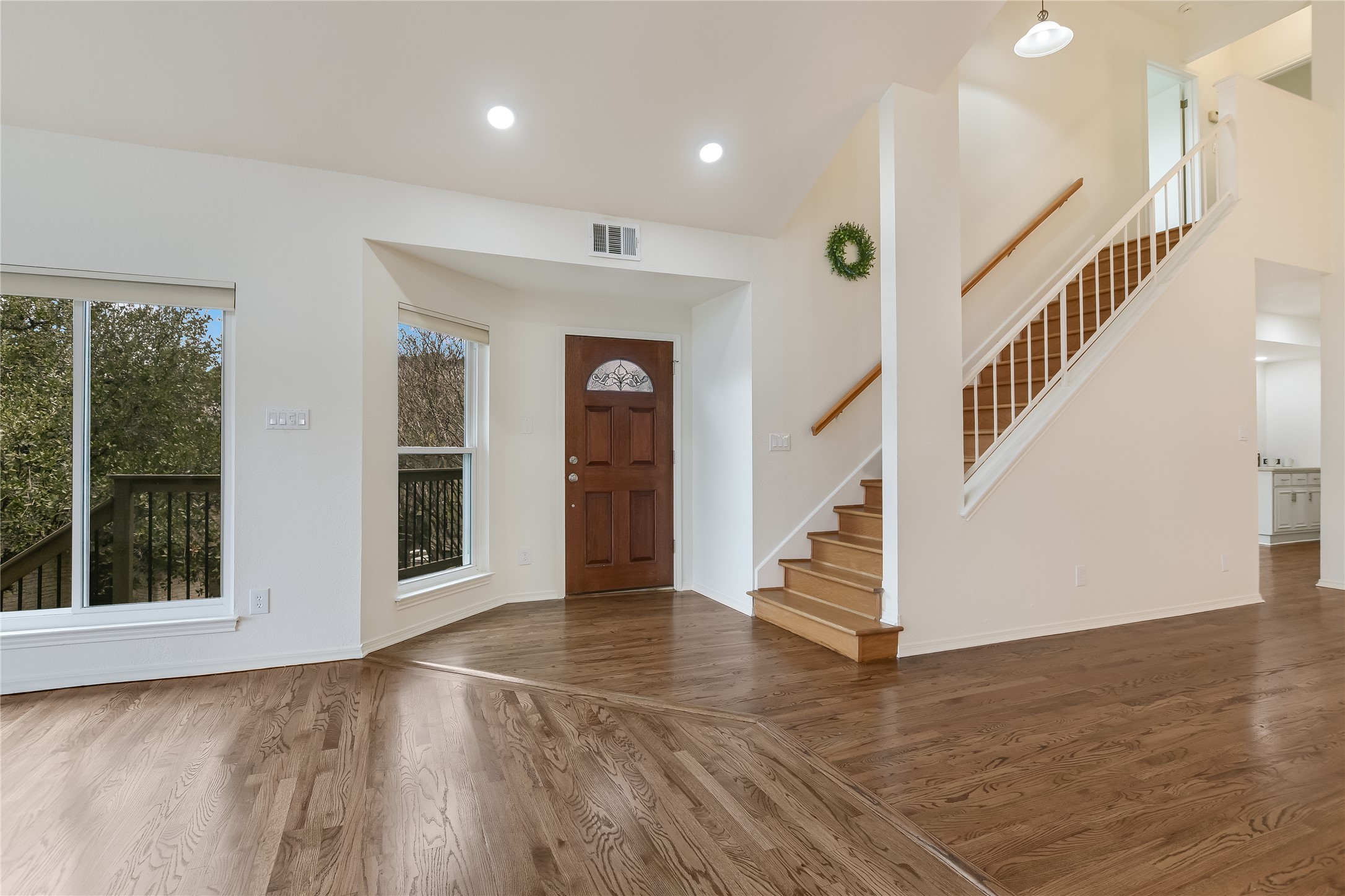 4906 Bob Cat Run Austin, TX 78731 - Photo 5 of 40 a view of an entryway with wooden floor windows and a livingroom