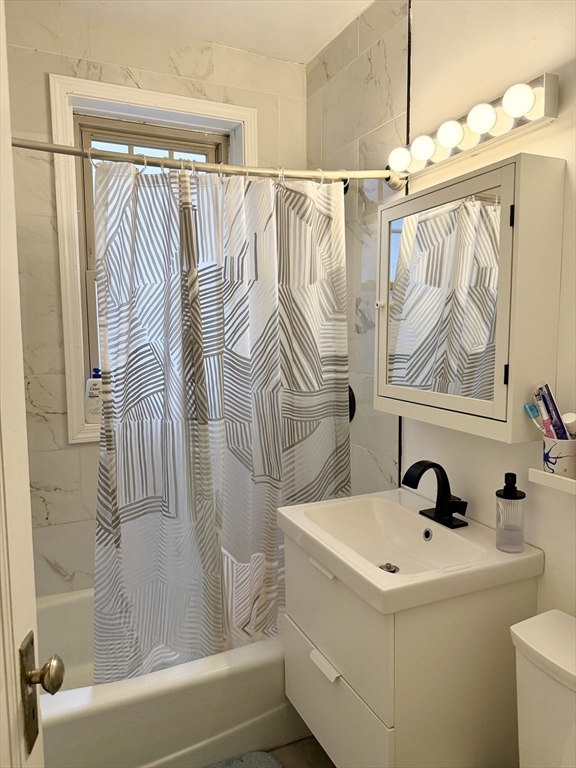 335 South Huntington Avenue, Unit 1 Boston, MA 02130 - Photo 4 of 11 a bathroom with a sink and mirror with bathtub