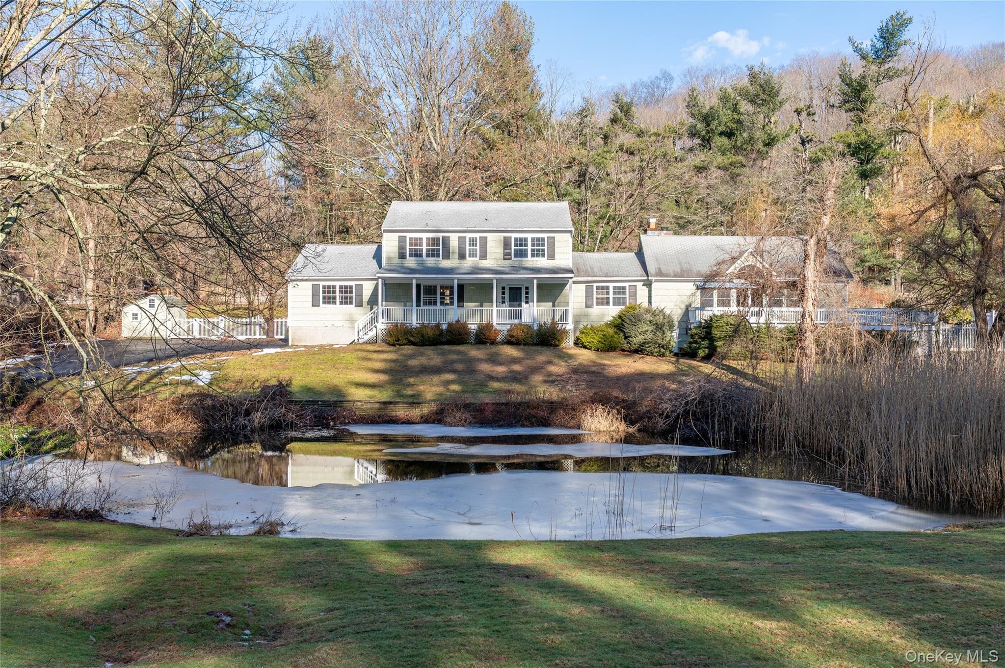58 Millbrook Road Bedford, NY 10506 - Photo 1 of 41 a swimming pool view with a lake view