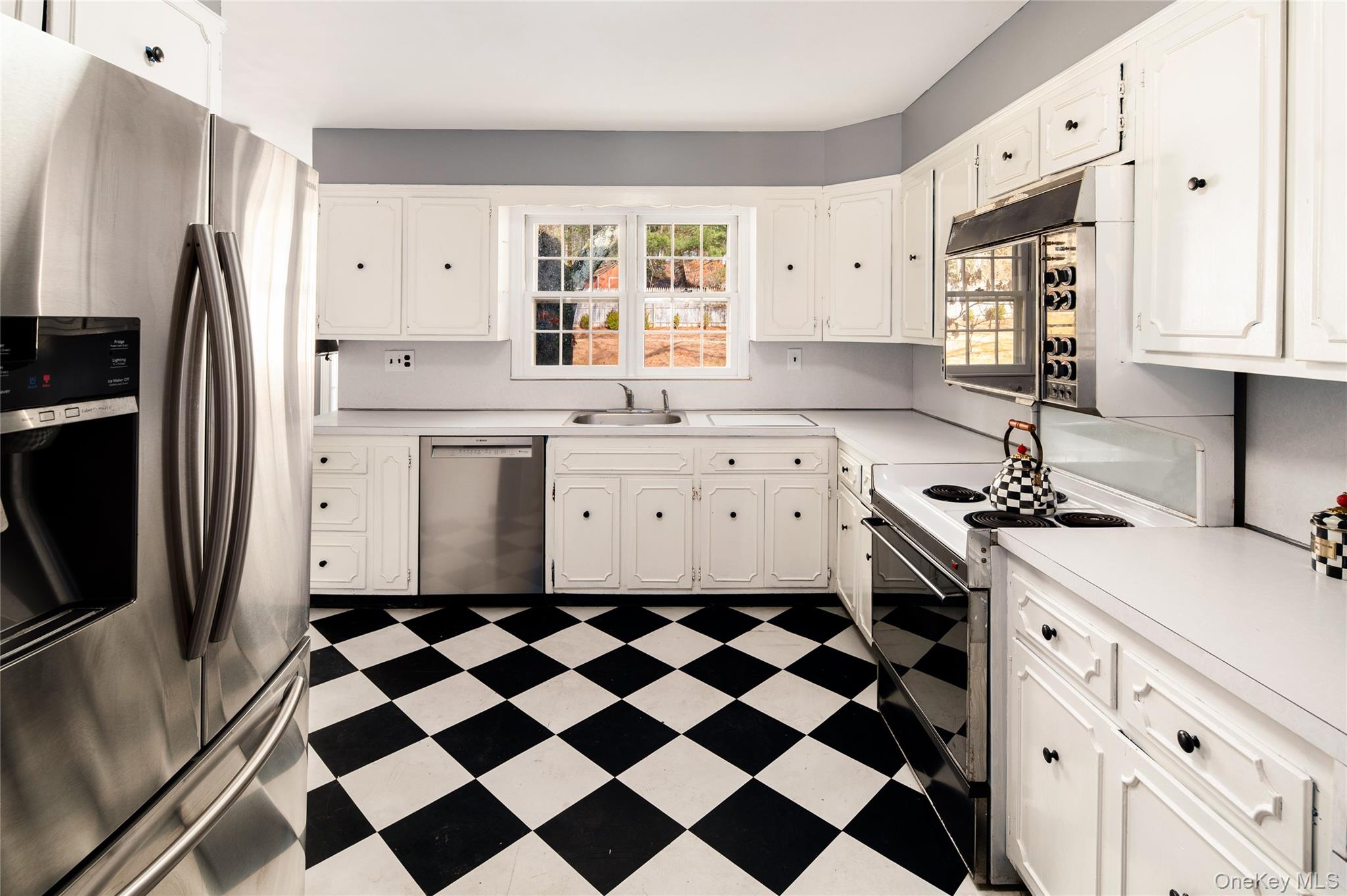 58 Millbrook Road Bedford, NY 10506 - Photo 13 of 41 a kitchen with a sink a refrigerator and white cabinets