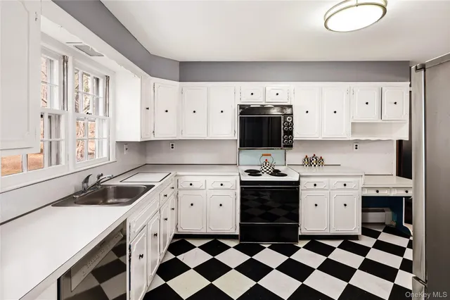 a kitchen with a stove a sink and a refrigerator