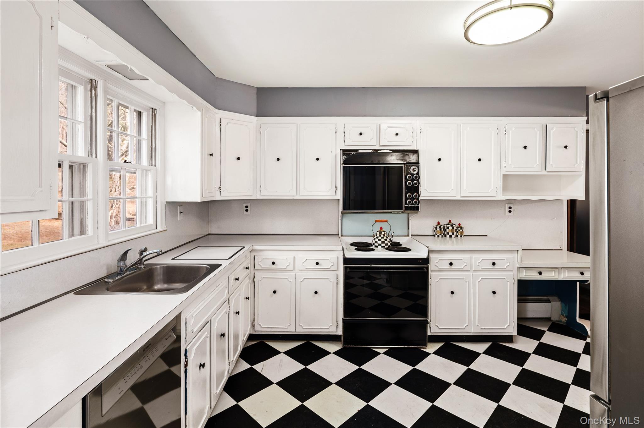 58 Millbrook Road Bedford, NY 10506 - Photo 14 of 41 a kitchen with a stove a sink and a refrigerator