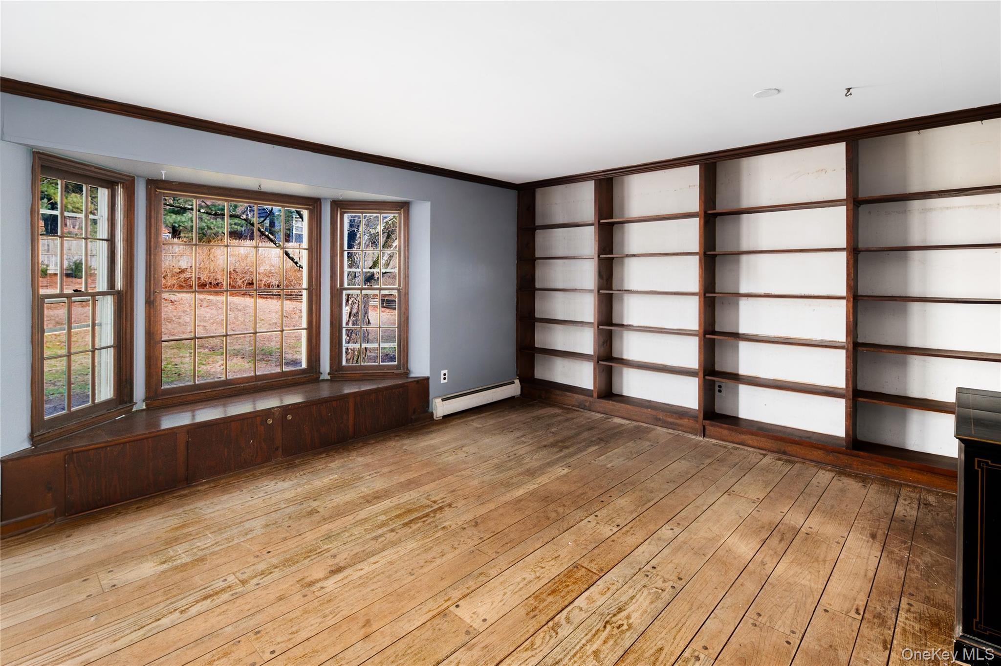 58 Millbrook Road Bedford, NY 10506 - Photo 17 of 41 wooden floor in an empty room with a window
