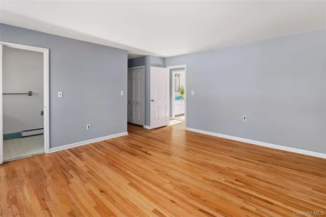 a view of an empty room and wooden floor