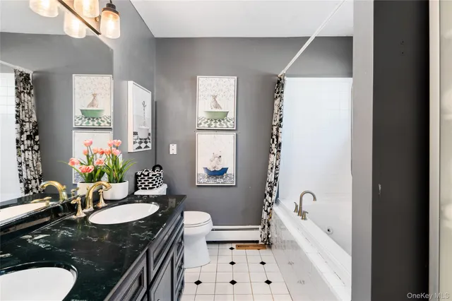 a bathroom with a granite countertop sink mirror and a bathtub