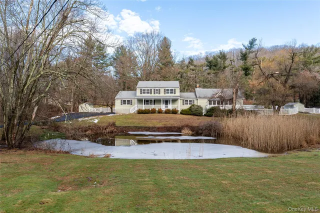 a view of a house with swimming pool and sitting area