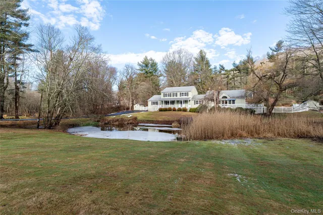 a view of a yard with a house on the side of the road