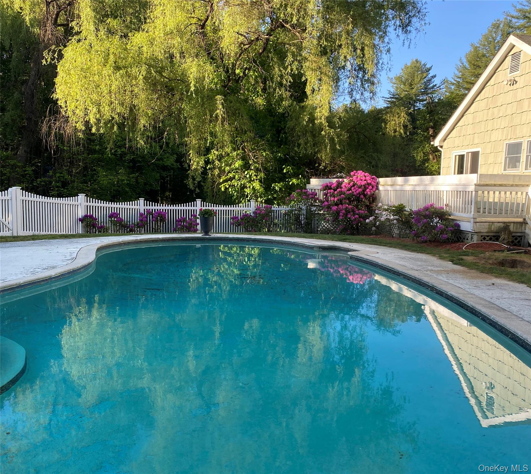 58 Millbrook Road Bedford, NY 10506 - Photo 33 of 41 a view of pool with seating area and trees around