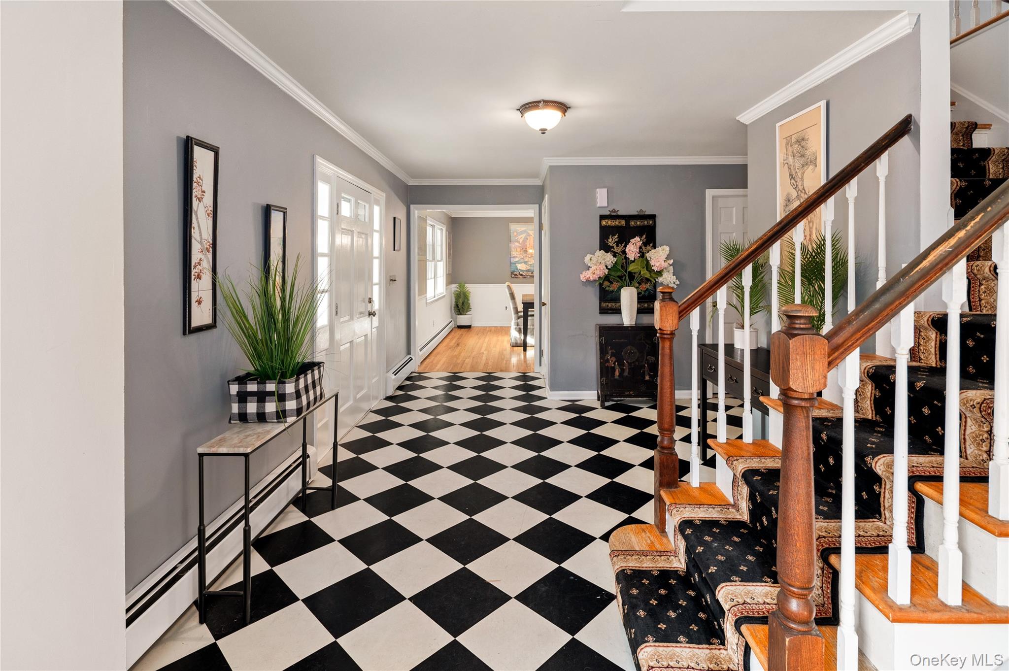 58 Millbrook Road Bedford, NY 10506 - Photo 4 of 41 a living room with a black white checkered floor with couches and a dining table with wooden floor